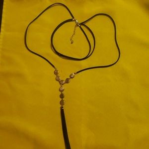 Black cord and silver colored necklace